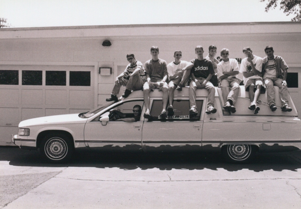 Soccer players sitting on hearse coached by Mike Jones